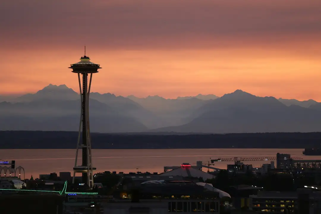 The Space Needle and the Seattle skyline against a golden evening sky