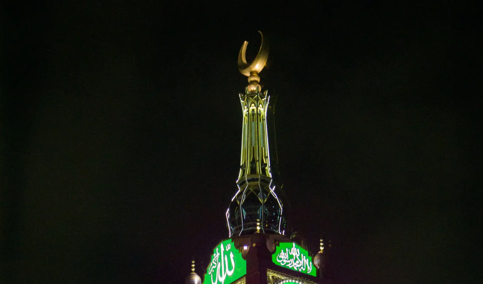 The Makkah clock tower lit green at night