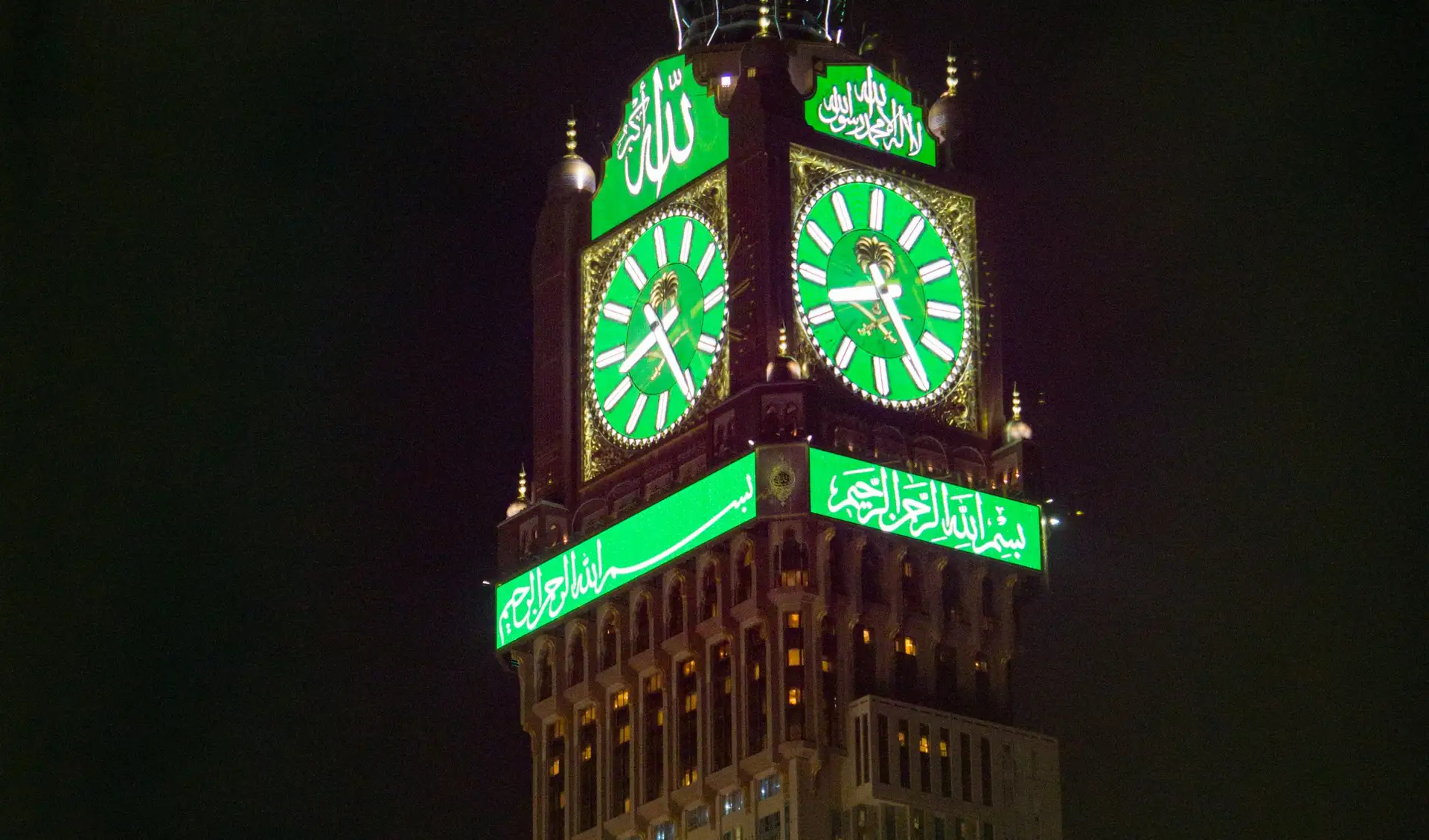 The Makkah clock tower lit green at night