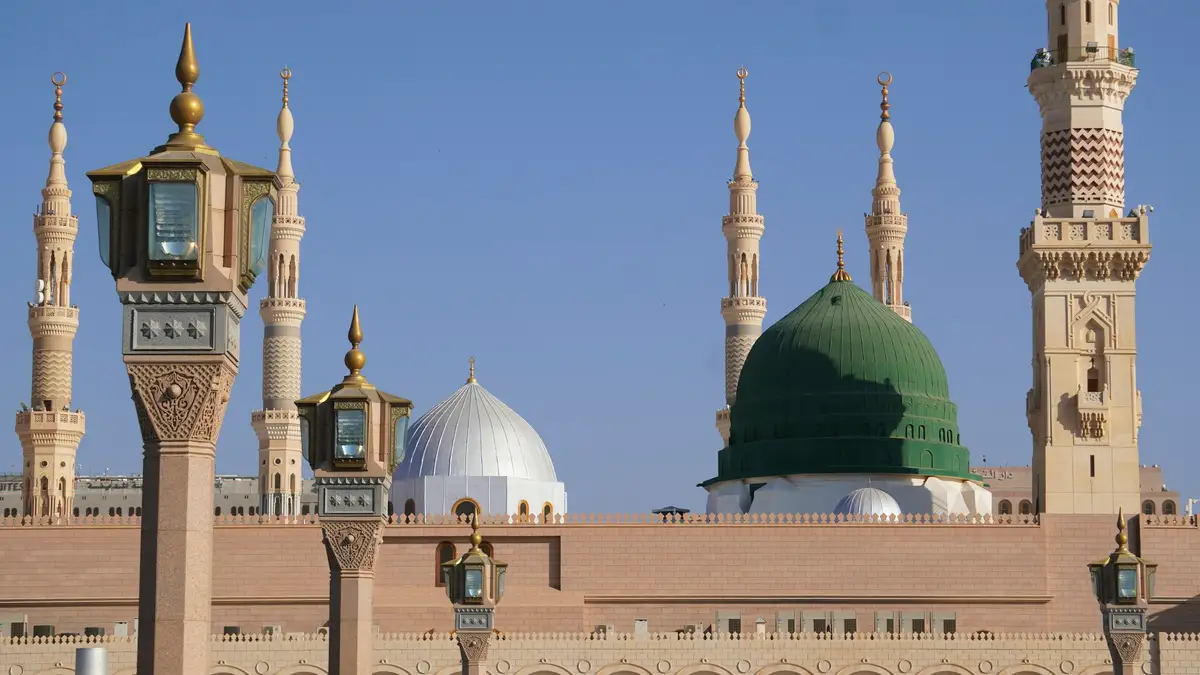 The Green Dome and minarets of the Prophet's Mosque against a clear sky
