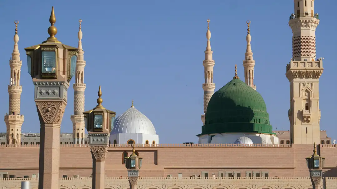 The Green Dome and minarets of the Prophet's Mosque against a clear sky