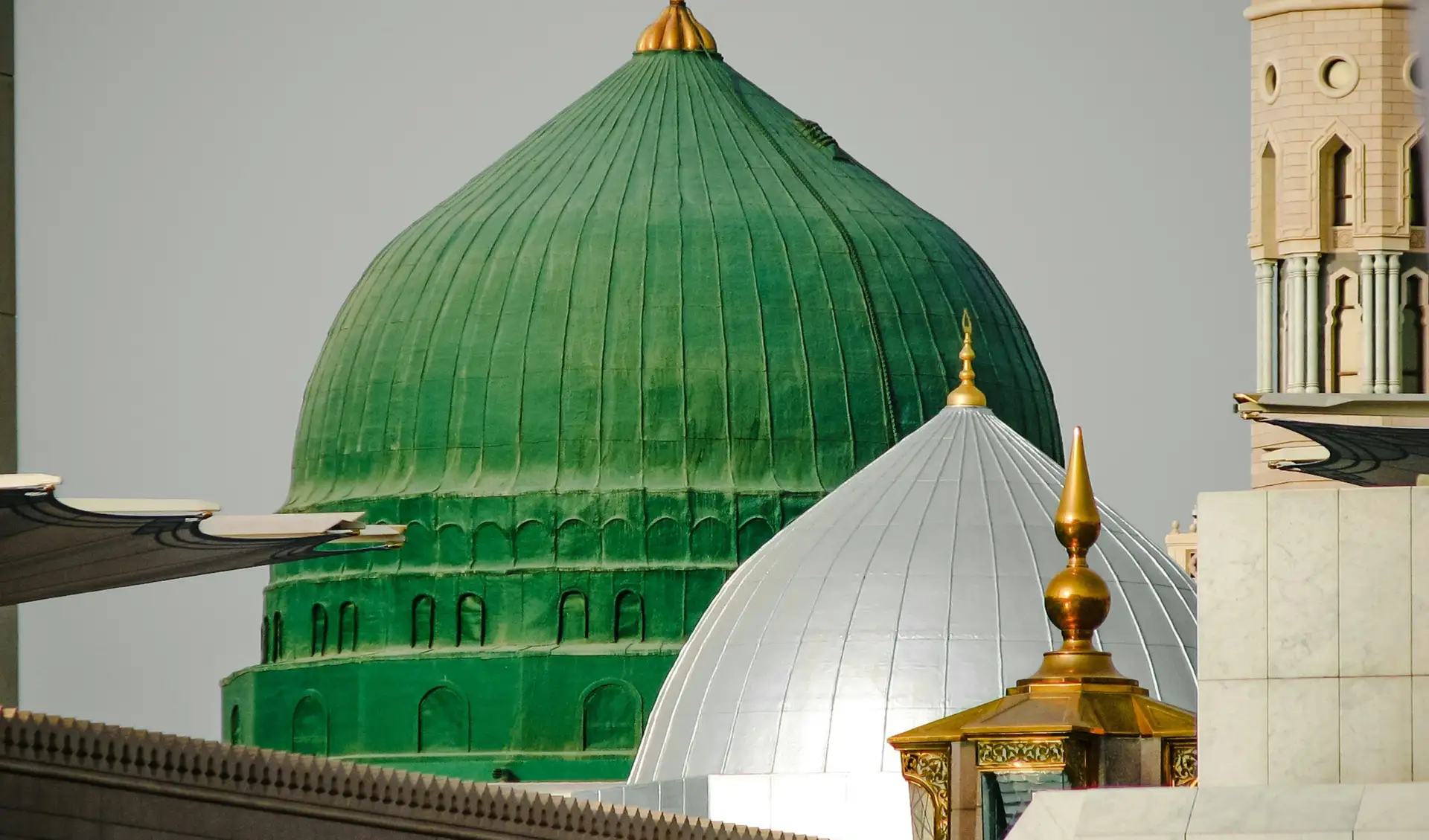 The Green Dome of the Prophet’s Mosque close up, its gilded finial beside the white dome