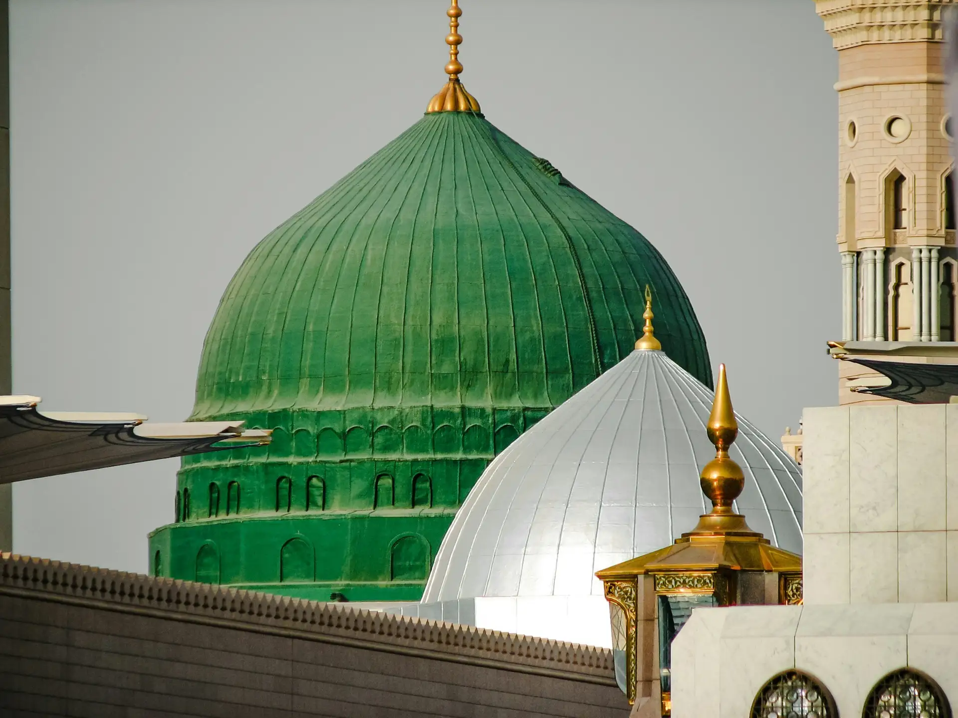 The Green Dome of the Prophet’s Mosque close up, its gilded finial beside the white dome