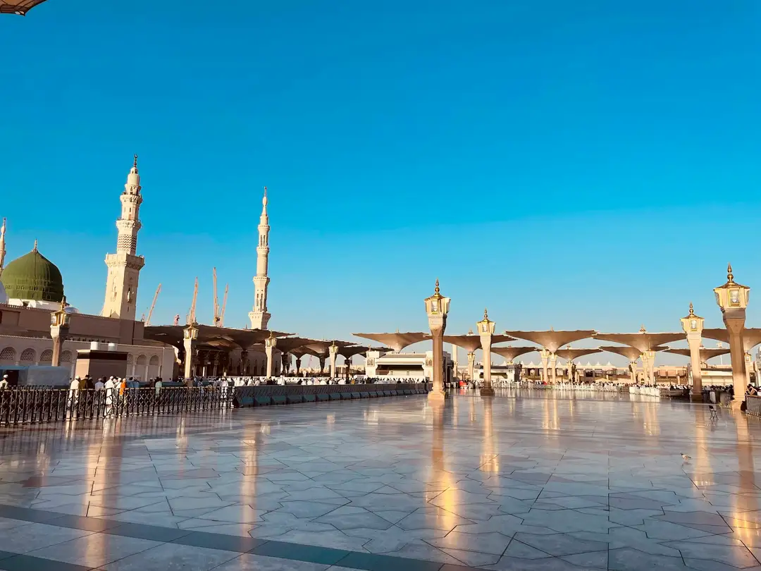 The marble courtyard of Masjid al-Haram beneath the clock tower