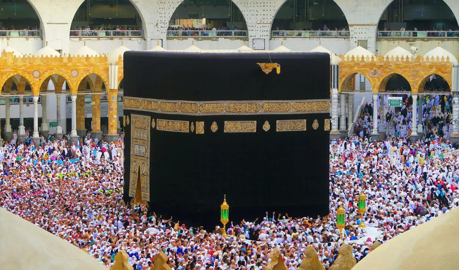 The Kaaba framed by the gilded arches of Masjid al-Haram