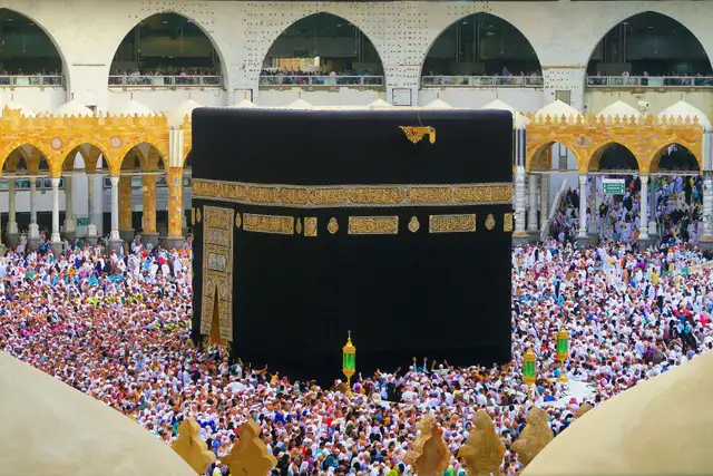 The Kaaba framed by the gilded arches of Masjid al-Haram