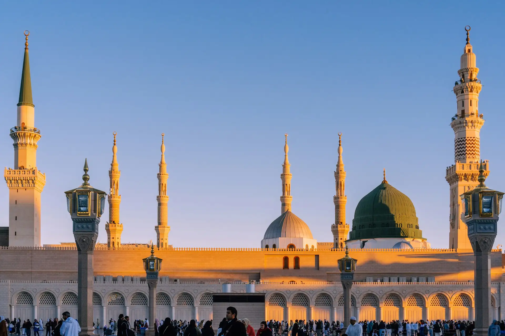 The minarets and domes of the Prophet’s Mosque in low golden light