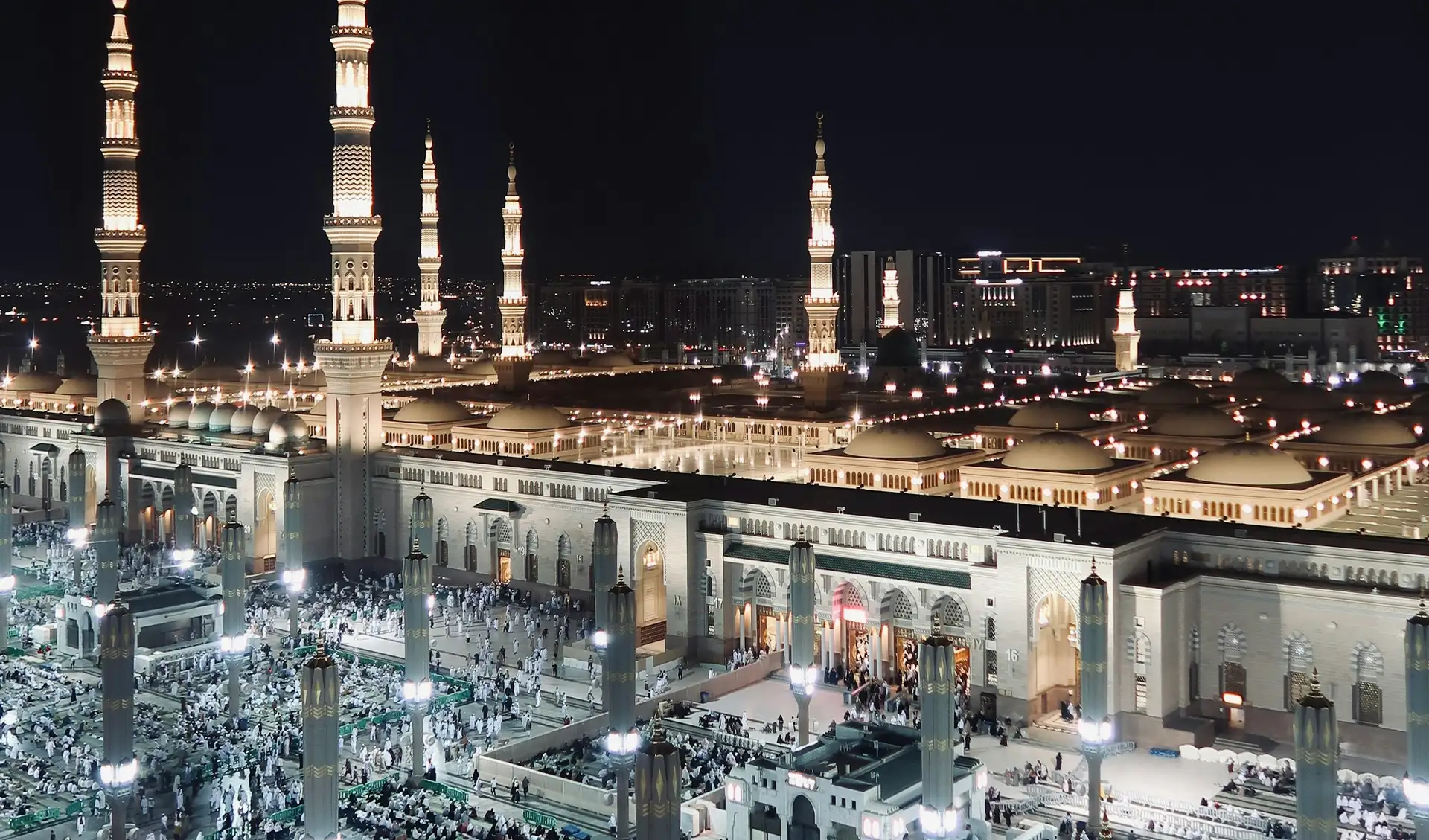 Masjid al-Haram and the towers of Makkah lit at night