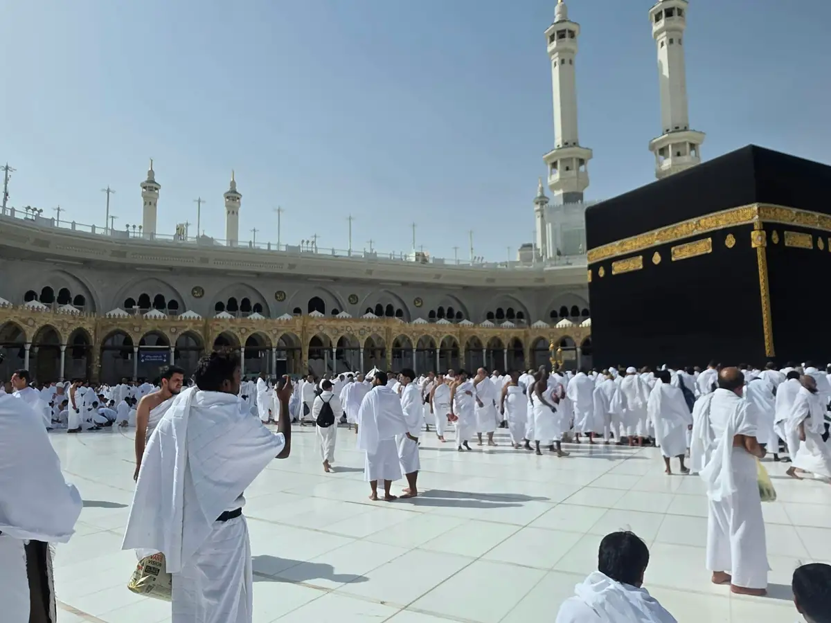 The courtyard of Masjid al-Haram filled with pilgrims around the Kaaba