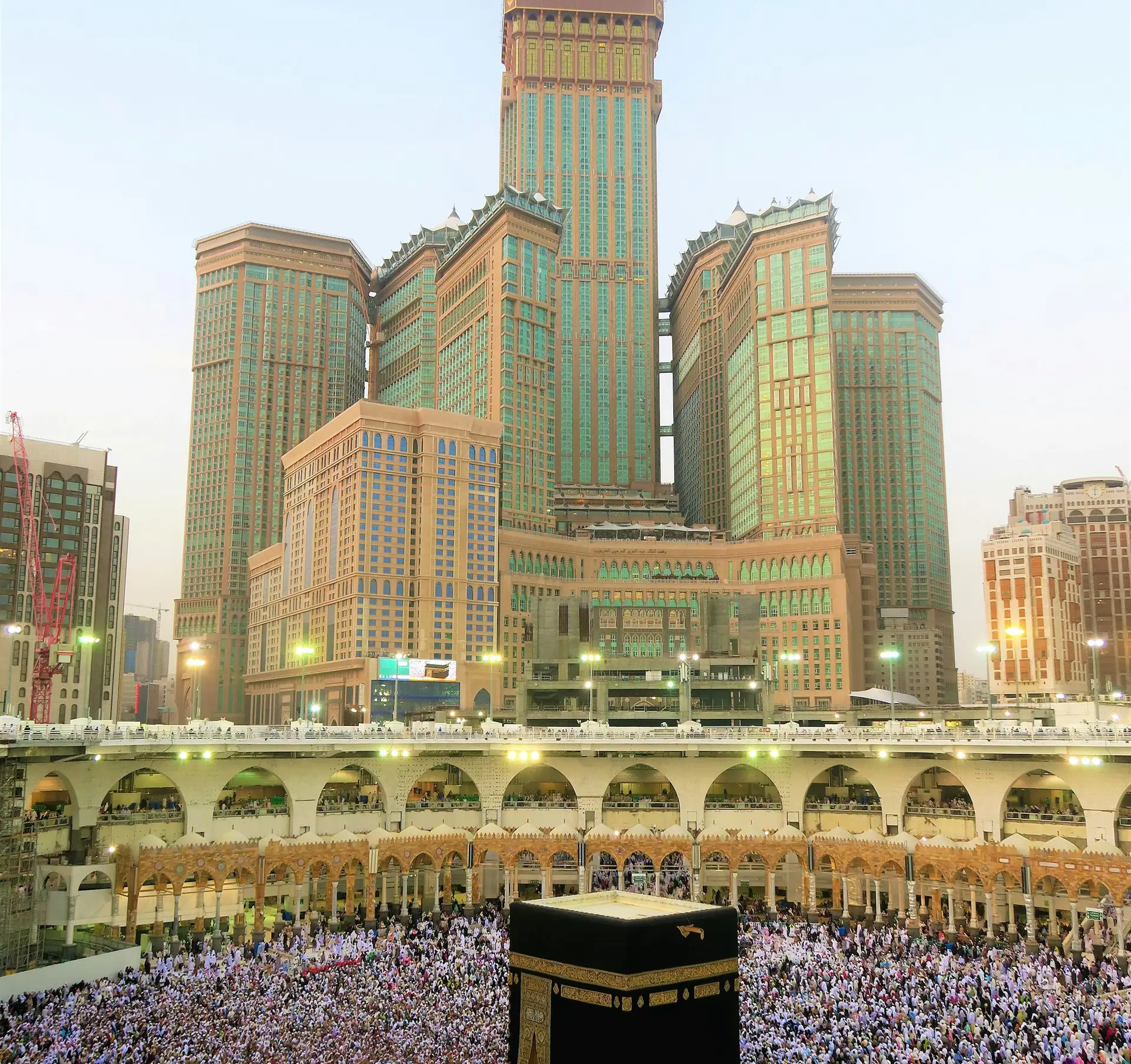 The Kaaba with the hotels of the clock tower rising behind the mosque