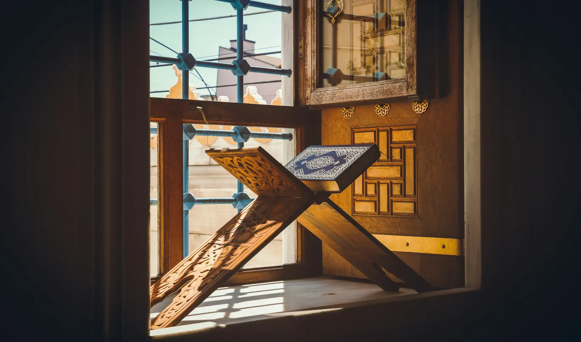 A Quran on a wooden stand in morning light